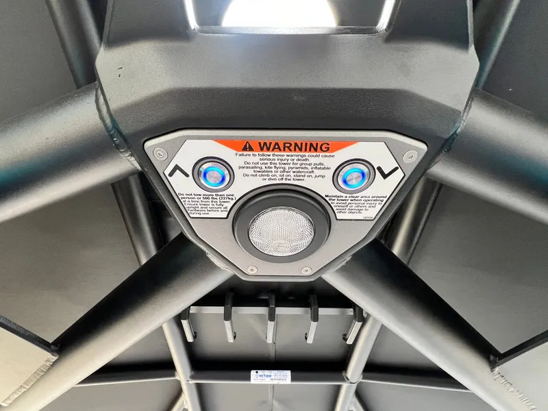 Slide: The Image of Control panel of 2026 Tigé 24RZX boat tower with warning label and buttons. - 41