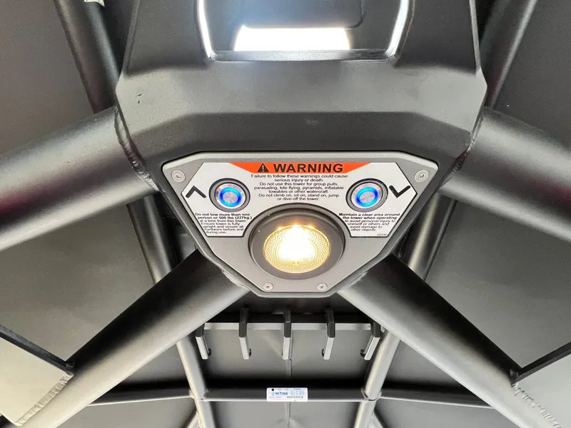 Slide: The Image of 2026 Tigé 24RZX boat tower with warning label and control buttons. - 42