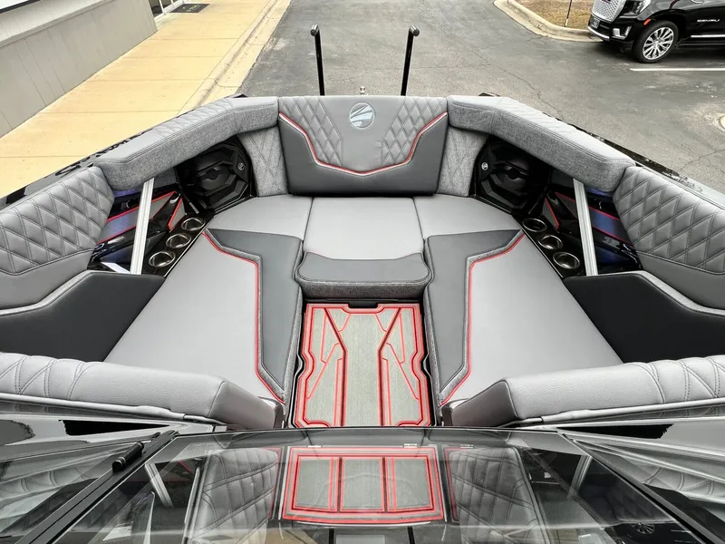 Slide: The Image of 2026 Tigé 24RZX boat interior with luxurious gray seating and red accents. - 44