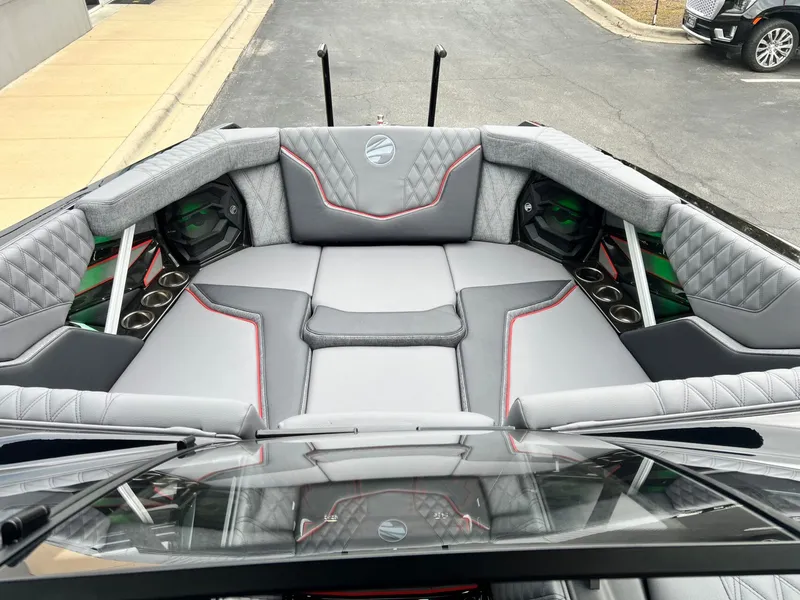 Slide: The Image of 2026 Tigé 24RZX boat interior with gray upholstery, red accents, and cup holders. - 45