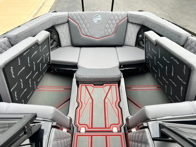 Slide: The Image of 2026 Tigé 24RZX boat interior with gray and red upholstery, featuring spacious seating and modern design. - 47