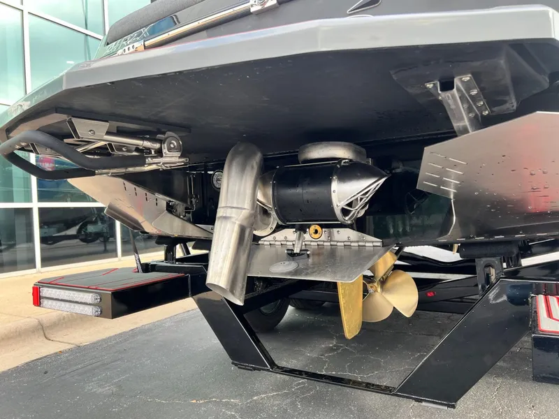 Slide: The Image of 2026 Tigé 24RZX boat underside showing propeller and exhaust system details. - 5