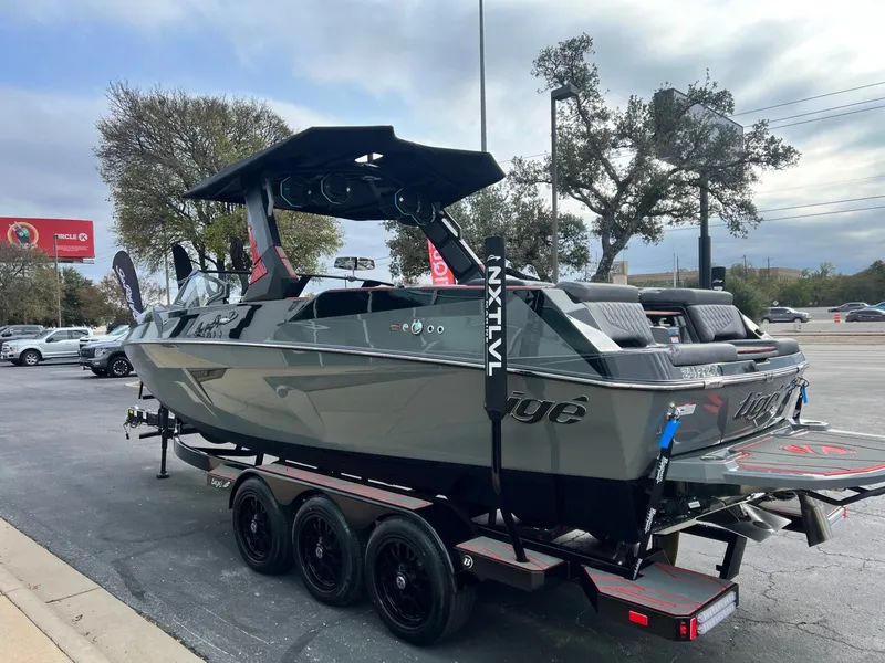 Slide: The Image of 2026 Tigé 24RZX boat on trailer, sleek design, parked outdoors. - 6