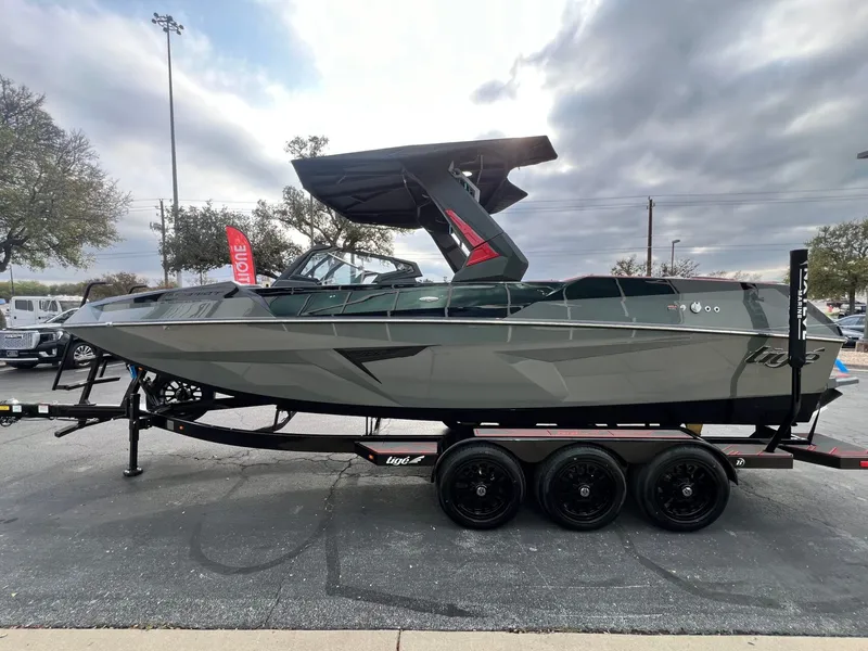 Slide: The Image of 2026 Tigé 24RZX boat on trailer, sleek design, overcast sky background. - 7