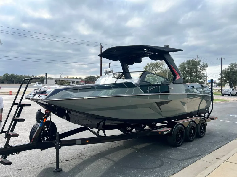 Slide: The Image of 2026 Tigé 24RZX boat on trailer, parked outdoors under cloudy sky. - 8