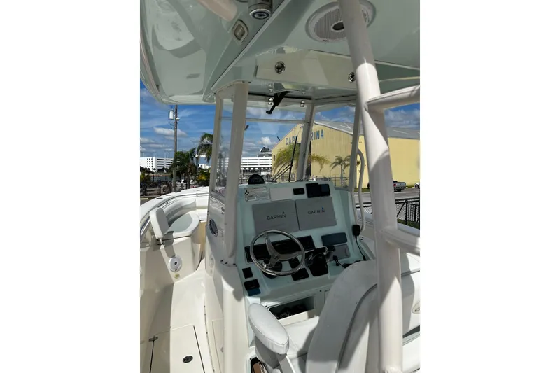 Slide: The Image of 2018 Cobia 301 Center Console boat interior with Garmin navigation system. - 11