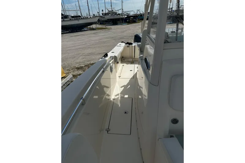 Slide: The Image of 2018 Cobia 301 Center Console boat interior with clean deck and railing. - 12