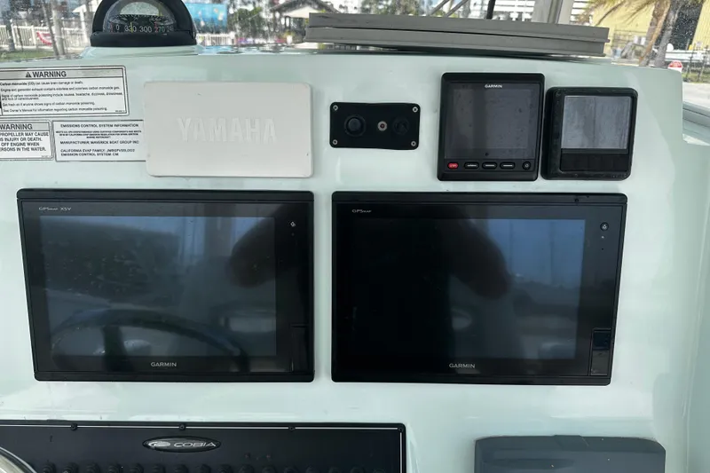 Slide: The Image of Dashboard of 2018 Cobia 301 Center Console with Garmin displays and Yamaha controls. - 3