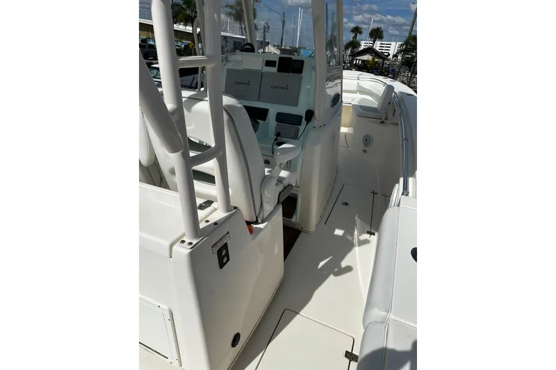 Slide: The Image of 2018 Cobia 301 Center Console boat interior with helm and seating area. - 4