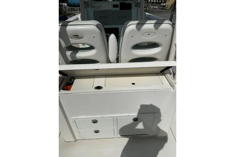Slide: The Image of 2018 Cobia 301 Center Console boat interior with seating and storage compartments. - 5