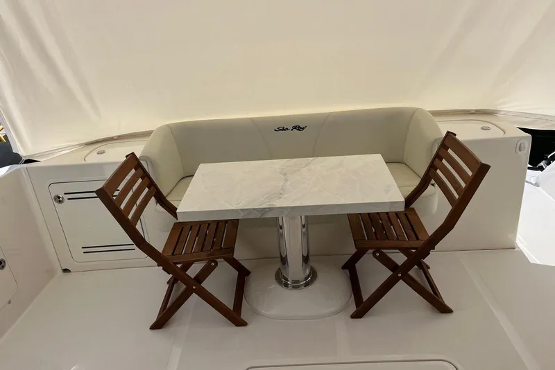 Slide: The Image of 2006 Sea Ray 52 Sedan Bridge yacht with elegant seating and a marble table. - 12