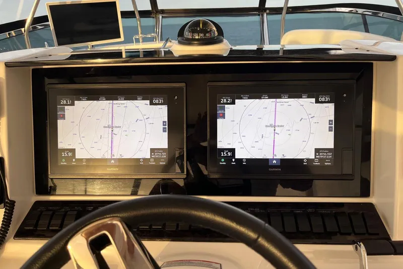 Slide: The Image of Helm of 2006 Sea Ray 52 Sedan Bridge with dual Garmin navigation displays. - 18