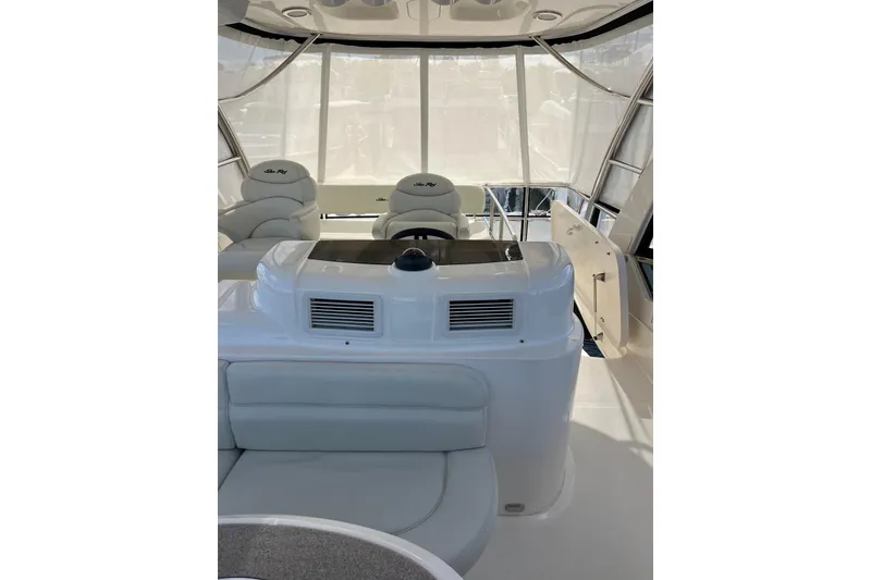 Slide: The Image of 2006 Sea Ray 52 Sedan Bridge interior with helm and seating area. - 23