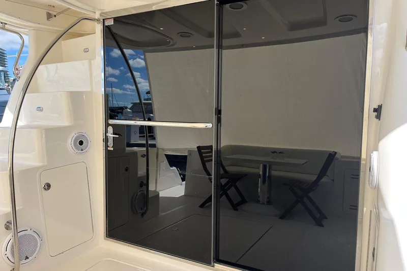 Slide: The Image of 2006 Sea Ray 52 Sedan Bridge yacht with sleek glass door and outdoor seating. - 26