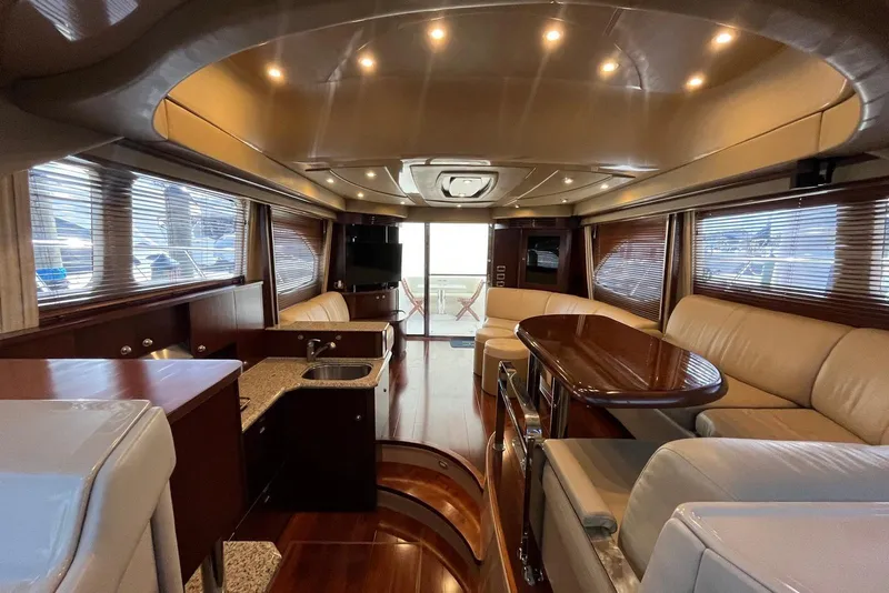 Slide: The Image of Luxurious interior of a 2006 Sea Ray 52 Sedan Bridge yacht with elegant seating and wood finishes. - 28