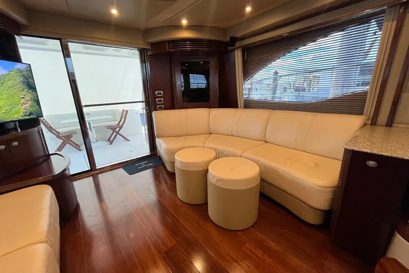 Slide: The Image of Luxurious interior of 2006 Sea Ray 52 Sedan Bridge yacht with leather seating and wood flooring. - 29