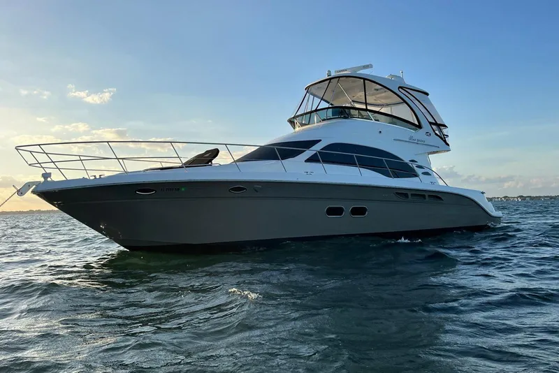Slide: The Image of 2006 Sea Ray 52 Sedan Bridge yacht on open water at sunset. - 3