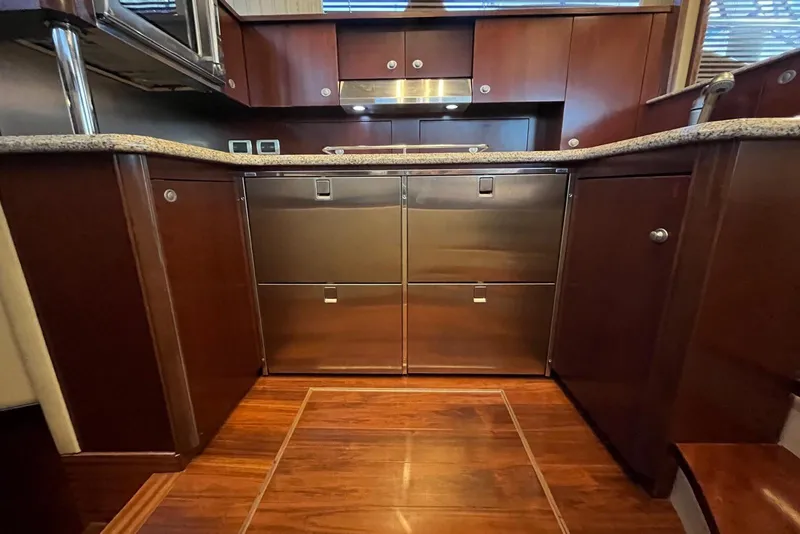 Slide: The Image of Luxurious 2006 Sea Ray 52 Sedan Bridge yacht kitchen with wood cabinetry and stainless steel appliances. - 33
