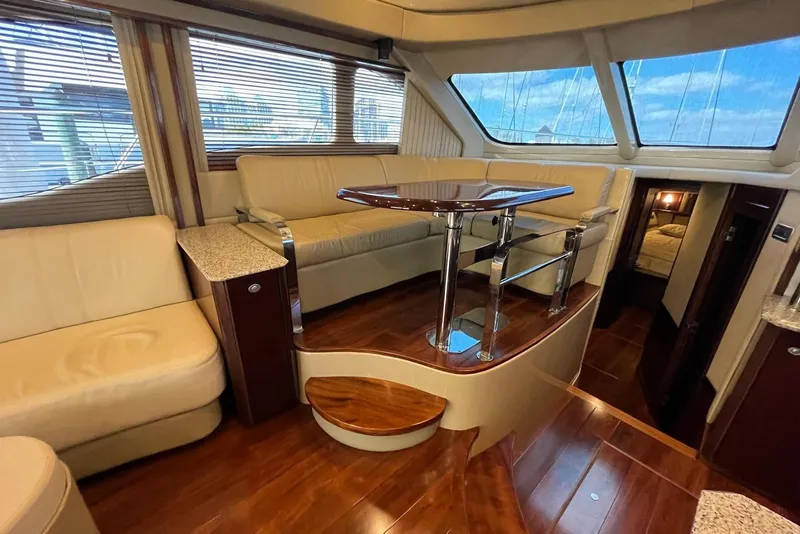 Slide: The Image of Luxurious interior of 2006 Sea Ray 52 Sedan Bridge yacht with elegant seating and wooden flooring. - 34