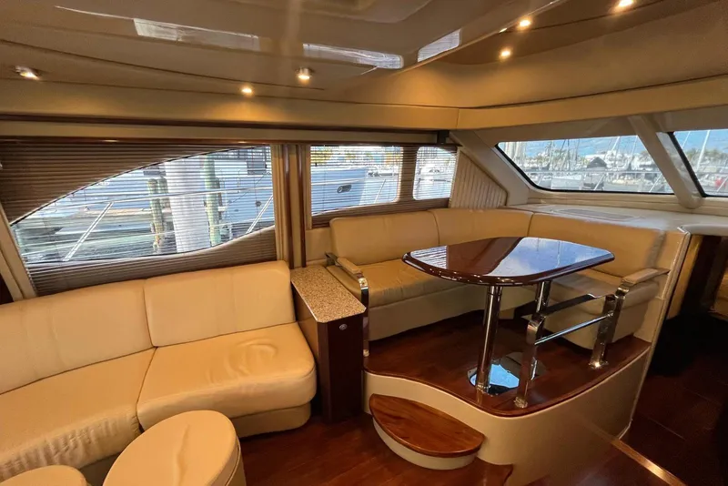 Slide: The Image of Luxurious interior of a 2006 Sea Ray 52 Sedan Bridge yacht with elegant seating and table. - 35