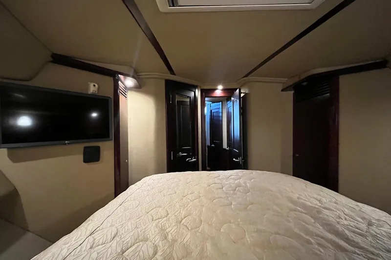 Slide: The Image of Interior cabin of 2006 Sea Ray 52 Sedan Bridge with TV and bed. - 45