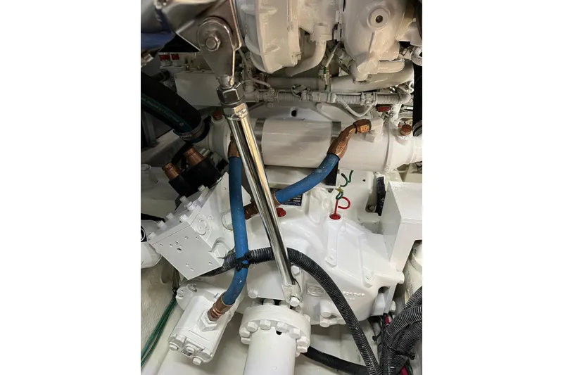 Slide: The Image of Engine compartment of a 2006 Sea Ray 52 Sedan Bridge with visible hoses and components. - 49