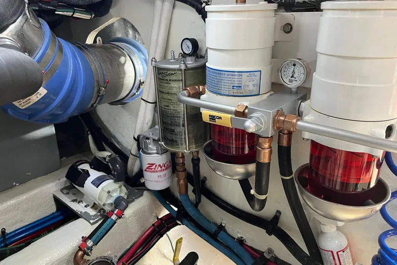 Slide: The Image of Engine room of 2006 Sea Ray 52 Sedan Bridge with fuel filters and hoses. - 50