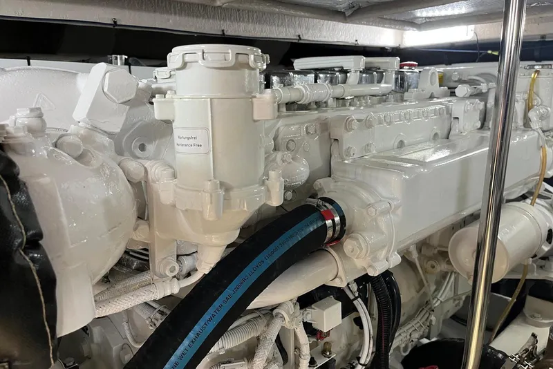 Slide: The Image of Engine compartment of a 2006 Sea Ray 52 Sedan Bridge, showcasing detailed machinery. - 52