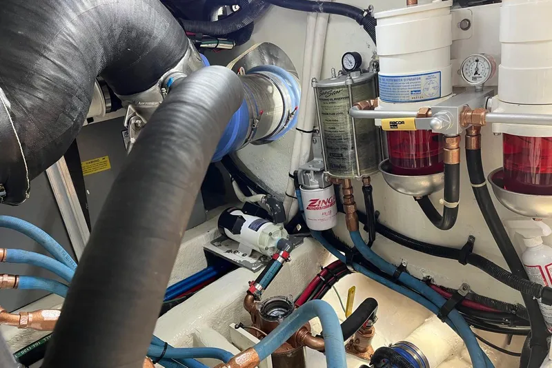 Slide: The Image of Engine room of 2006 Sea Ray 52 Sedan Bridge with fuel filters and hoses. - 58