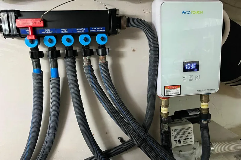 Slide: The Image of 2006 Sea Ray 52 Sedan Bridge water system with EcoTouch electric heater and labeled valves. - 59