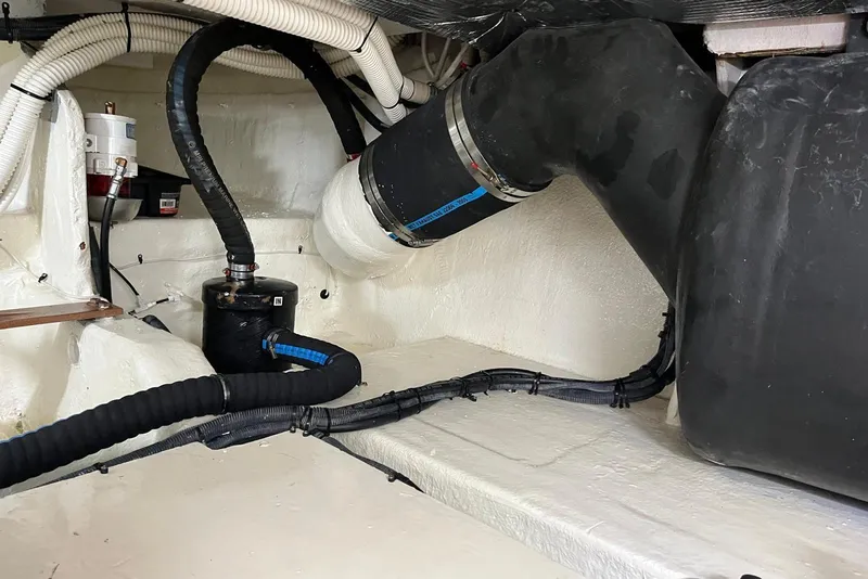 Slide: The Image of Engine compartment of 2006 Sea Ray 52 Sedan Bridge with hoses and components. - 62