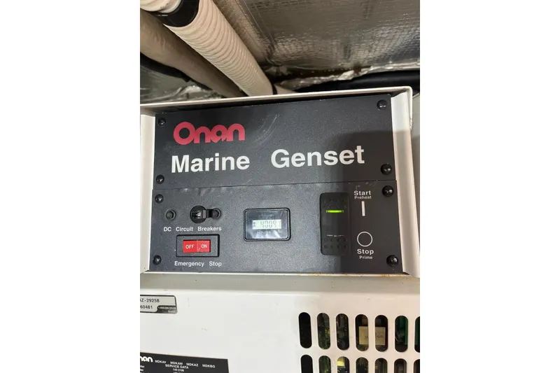 Slide: The Image of Onan Marine Genset control panel on 2006 Sea Ray 52 Sedan Bridge. - 65