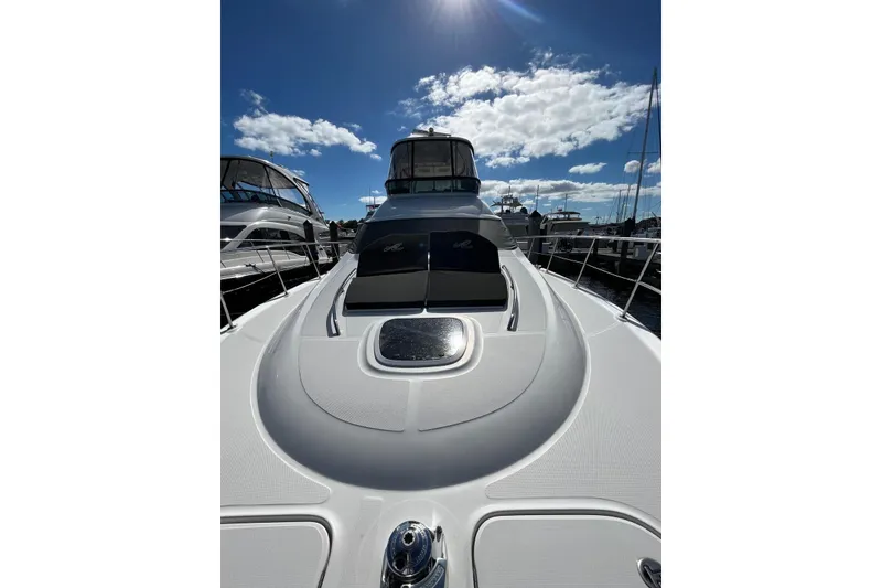 Slide: The Image of 2006 Sea Ray 52 Sedan Bridge yacht under clear blue sky at marina. - 7