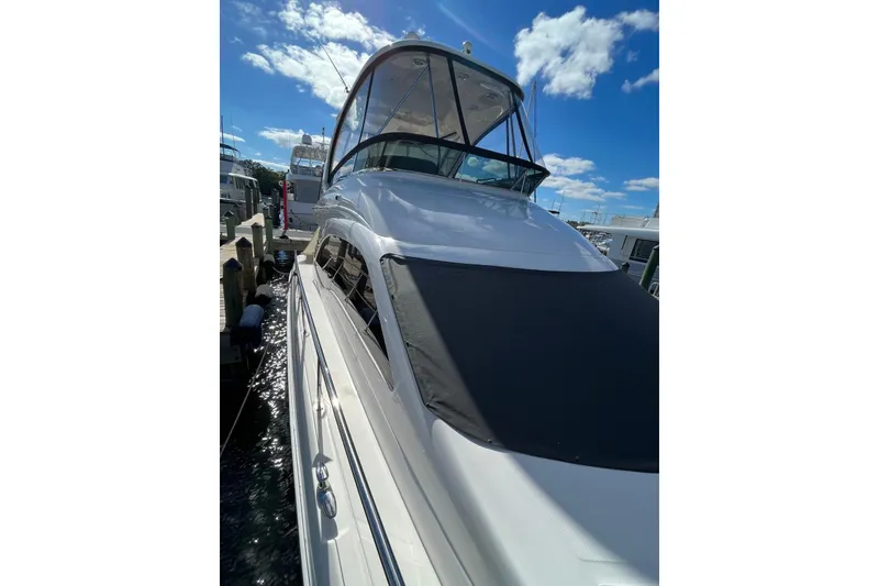 Slide: The Image of 2006 Sea Ray 52 Sedan Bridge yacht docked under a clear blue sky. - 9