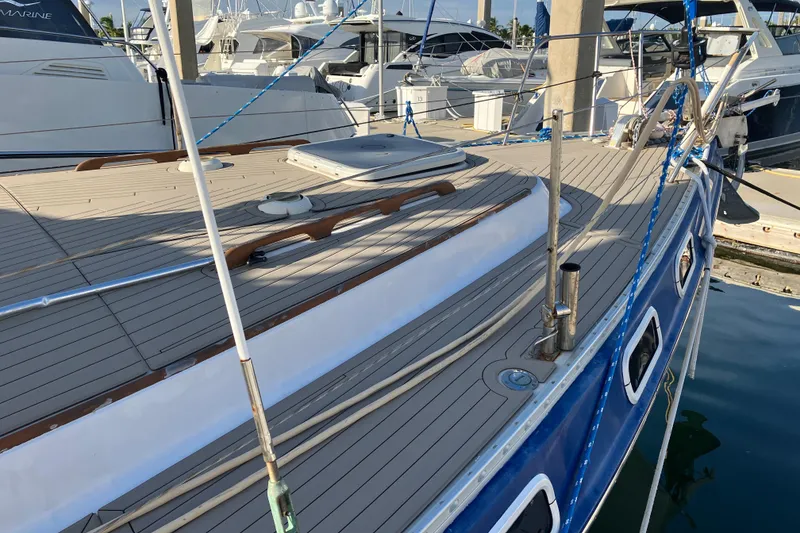 Slide: The Image of 1987 Morgan Classic 41 yacht docked at marina, showcasing sleek deck design. - 11