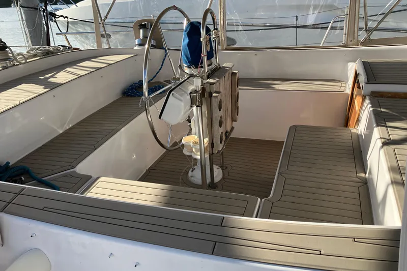 Slide: The Image of 1987 Morgan Classic 41 sailboat cockpit with wooden seating and steering wheel. - 12