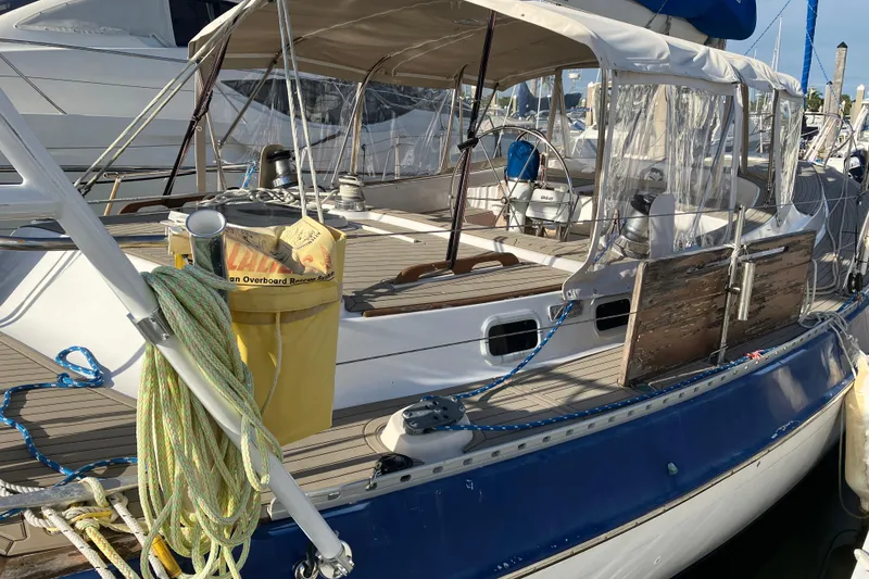 Slide: The Image of 1987 Morgan Classic 41 sailboat docked, featuring deck details and nautical equipment. - 13