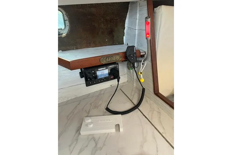 Slide: The Image of 1987 Morgan Classic 41 boat interior with Simrad radio and captain's sign. - 15