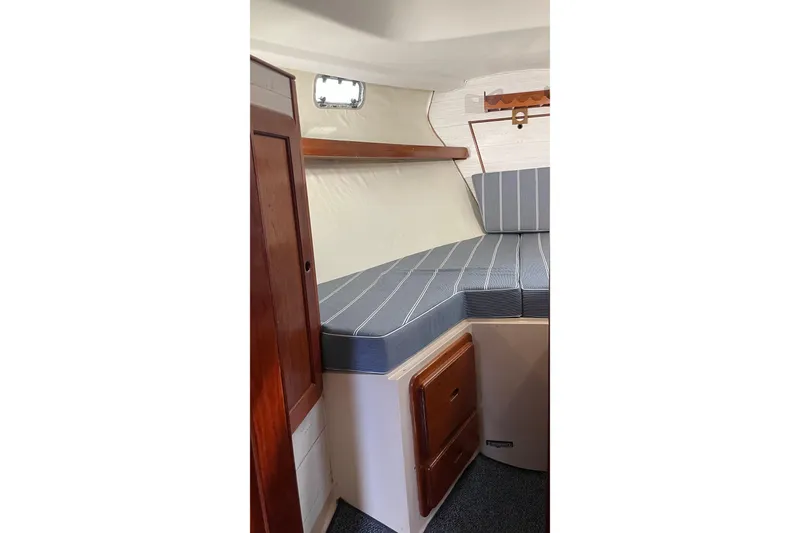 Slide: The Image of 1987 Morgan Classic 41 yacht interior with striped cushions and wooden cabinetry. - 5