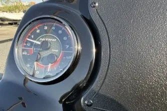 Slide: The Image of Close-up of a 2026 Nitro Z17 speedometer on a textured dashboard. - 2