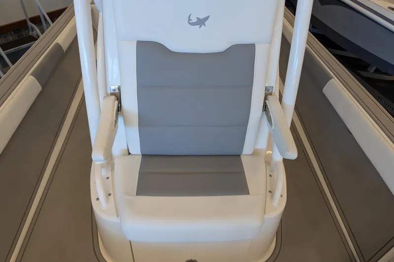 Slide: The Image of Captain's chair on 2026 Mako 24 APEX boat, featuring sleek gray and white design. - 10