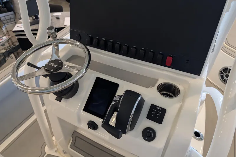 Slide: The Image of Steering console of 2026 Mako 24 APEX boat with controls and touchscreen display. - 11