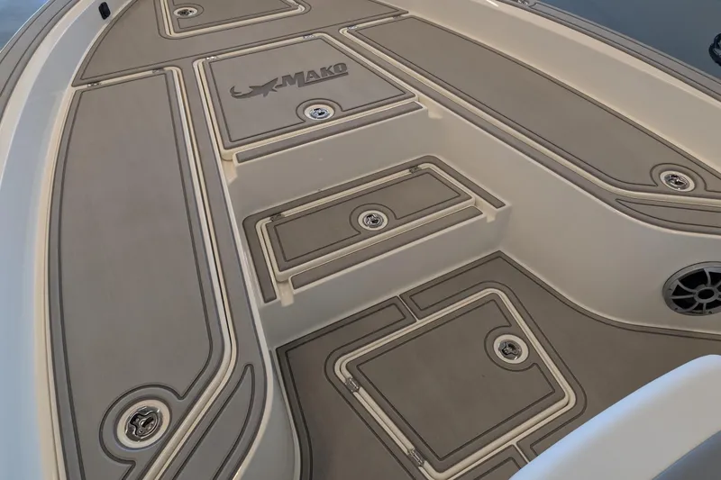 Slide: The Image of Deck of 2026 Mako 24 APEX boat with storage compartments and logo. - 9