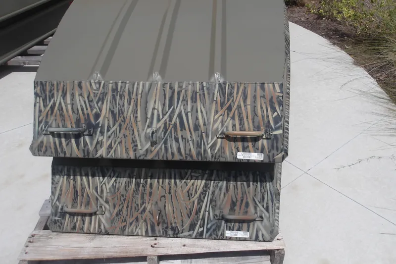 The Image of 2026 Tracker Grizzly 15 Jon boat with camouflage design on display outdoors. - 0