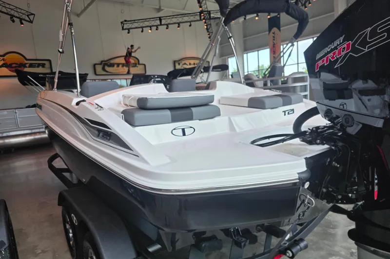 Slide: The Image of 2026 Tahoe T21 boat with Mercury Pro XS engine in showroom setting. - 92