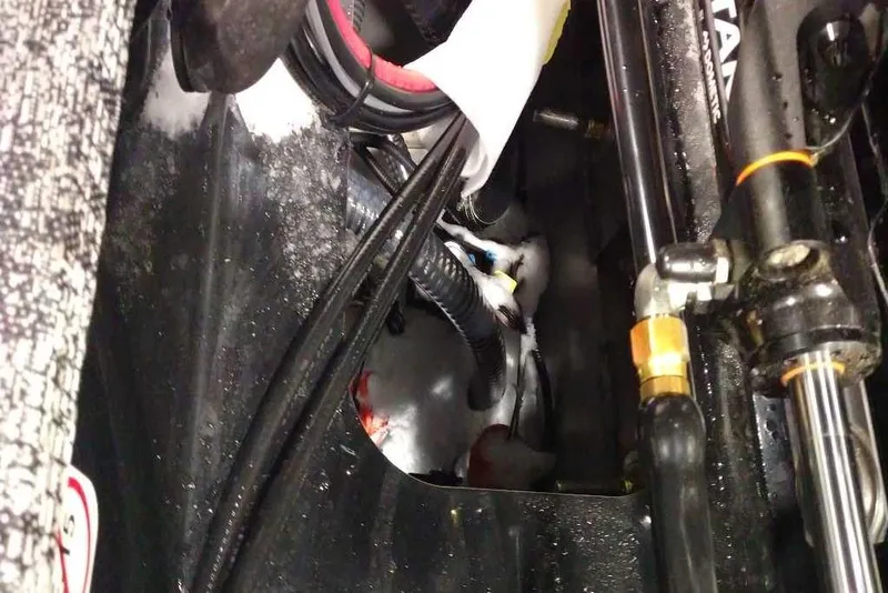 Slide: The Image of Engine compartment of 2026 Tracker Targa V-18 Combo with visible wiring and components. - 77