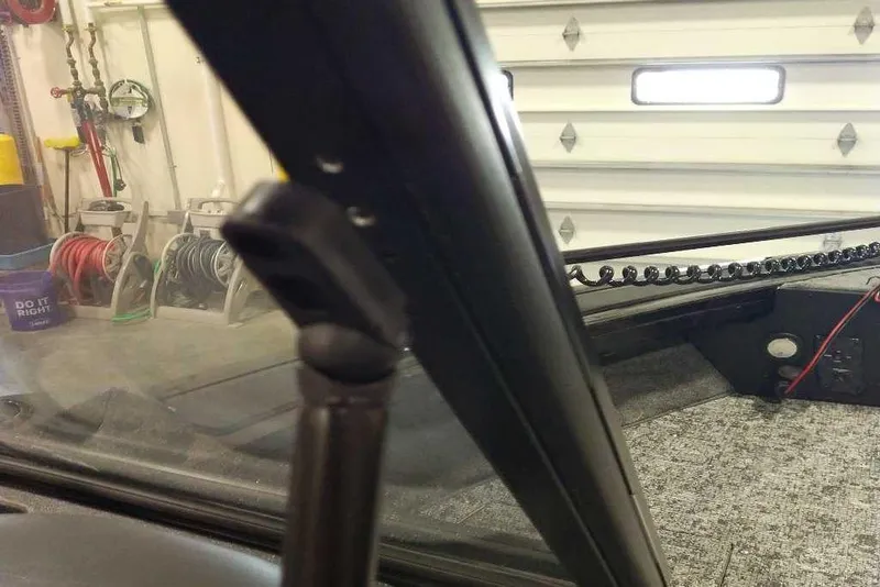 Slide: The Image of 2026 Tracker Targa V-18 Combo interior, garage setting, visible equipment and coiled cable. - 78