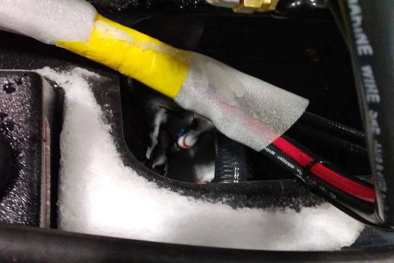 Slide: The Image of Close-up of wiring and insulation in a 2026 Tracker Targa V-18 Combo boat. - 79