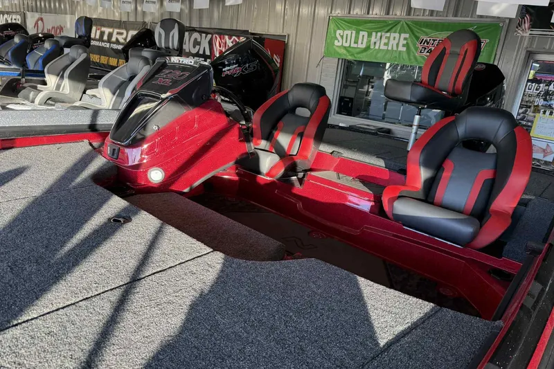 Slide: The Image of 2026 Nitro Z20 XL Pro boat interior with red and black seats, displayed in showroom. - 116