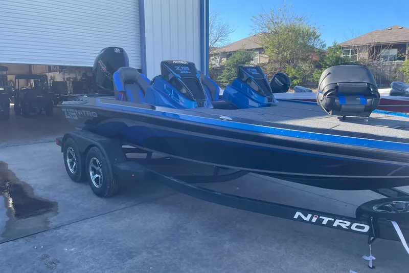 The Image of 2026 Nitro Z19 XL Pro boat in blue, parked outside a garage. - 0